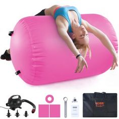 a woman laying on top of a pink inflatable pillow