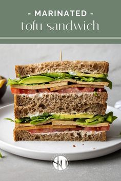 a sandwich is stacked on top of each other with lettuce and tomato slices