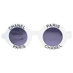 New Rare and Iconic Vintage Chanel " Chanel Paris " round sunglasses. A seldom and unique piece in this new, never displayed or worn condition. This pair of Chanel sunglasses is an absolute showstopper. This pair may show minor sign of wear due to storage. Italy Sunglasses, Paris Italy, Chanel Suit, Sunglasses White, Expensive Shoes, Chanel Brand, Silver Sunglasses, White Sunglasses, Chanel Logo