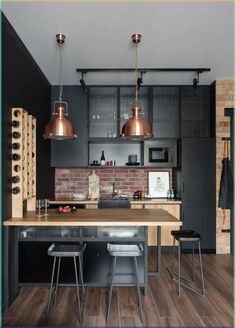 Industrial Open-concept Kitchen Ideas with Brick Backsplash and Wood Countertops A cool and masculine look is created in this industrial open-concept kitchen design, which consists of black and wood flat-panel cabinets, wood countertops, and a brick backsplash. Modern Industrial Kitchen, Industrial Kitchen Design, Industrial Home Design, Loft Kitchen, Industrial Style Kitchen, Loft Interior, Kabinet Dapur, Brick Backsplash, Loft Interiors