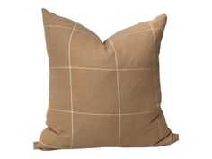 a brown pillow with white squares on the front and back, sitting on a white background