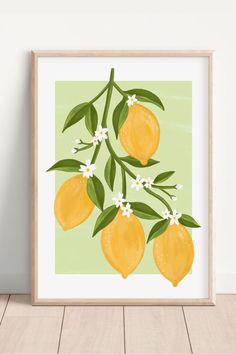 a lemon tree with flowers and leaves on a light green background in a wooden frame