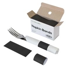 a knife, fork and two napkins in a box with the packaging on it