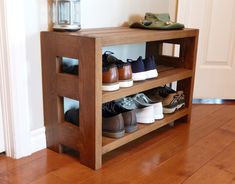 a wooden shelf with several pairs of shoes sitting on it's sides, and a lantern in the background