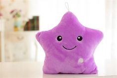 a purple star pillow sitting on top of a table