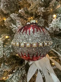 a christmas ornament hanging from the top of a tree