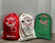 three drawsack bags sitting on the floor in front of a white wall and door