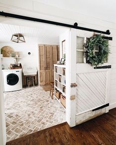 an open door leading to a laundry room with a washer and dryer in it