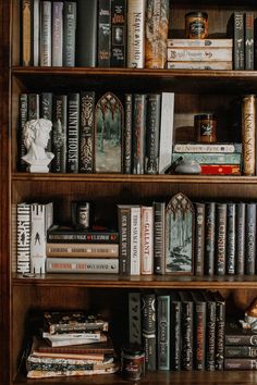 a bookshelf filled with lots of books on top of wooden shelves next to each other