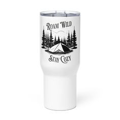 a white tumbler cup with the words roam wild stay cozy and a tent in the woods