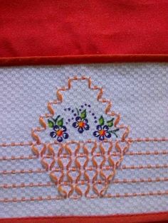 a close up of a piece of cloth with an embroidered design on the front and back