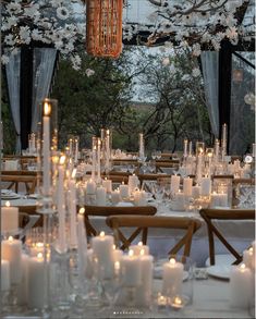 the tables are set with candles and place settings