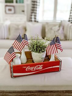 an old coca - cola crate is decorated with american flags and other patriotic decorations for the fourth of july