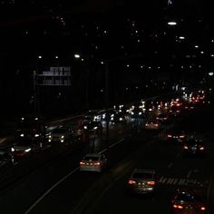 many cars are driving down the highway at night