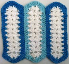 three crocheted blue and white items are lined up