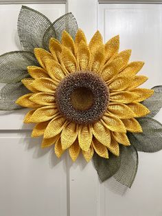 a sunflower is hanging on the front door