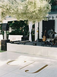 an outdoor stage set up for a wedding reception