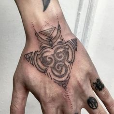 a person's hand with a tattoo on it