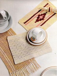 the table is set with dishes, cups and saucers