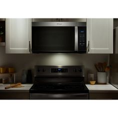 a microwave above a stove in a kitchen