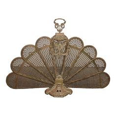 an antique fan with a man's head on it is sitting in front of a white background