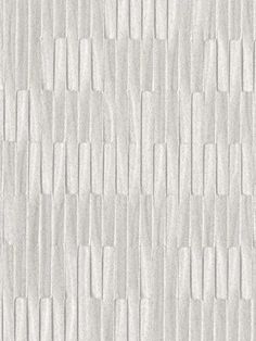 a white tile wall that is made up of small squares and strips on the surface