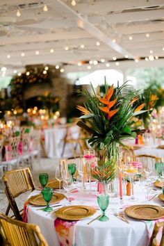 the tables are set with colorful flowers and place settings