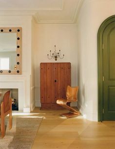 a living room filled with furniture and a fire place next to a mirror on the wall