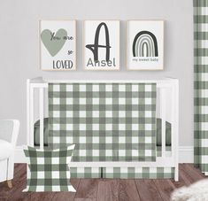 a baby's room with green and white checkered wallpaper, two pictures on the wall