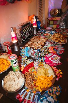 a table filled with lots of food and confetti on top of it's sides