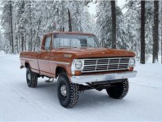 an old truck is parked in the snow