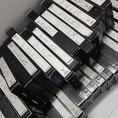 a pile of cassettes sitting next to each other on top of a white table