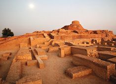 an ancient city in the desert at dusk