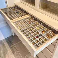 the drawers are filled with jewelry and earrings