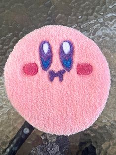 a close up of a pink object with eyes