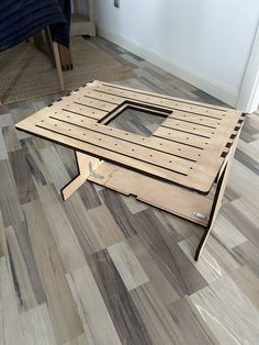 a coffee table made out of wooden planks on the floor in a living room