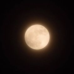 the full moon is seen in the dark sky