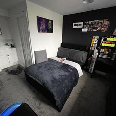 a bed room with a neatly made bed next to a book shelf filled with books