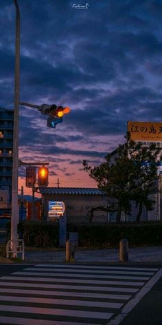 an airplane is flying over the city at night with its landing gear down and it's lights on