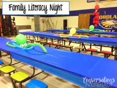 an empty classroom with blue tables and yellow chairs in front of them is the words family library night