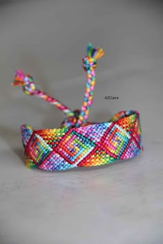 a colorful beaded headband with a knot on the top and two strings attached to it