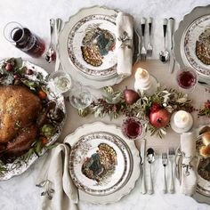 a table set for thanksgiving dinner with turkey and apples