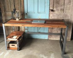 a wooden desk sitting in front of a blue door