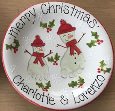 a christmas plate with two snowmen on it