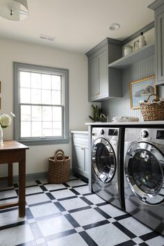 a washer and dryer in a room with checkered flooring on the floor