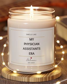 a white candle sitting on top of a wooden table