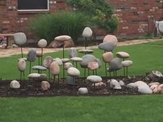 some rocks are in the middle of a flower bed