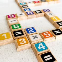 a wooden crossword game with numbers on it