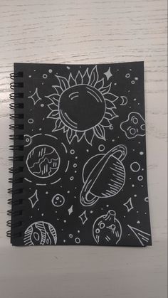 a black notebook with white drawings on it