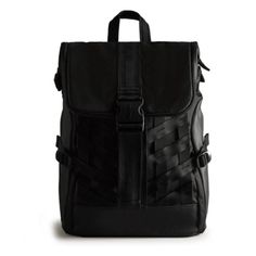 a black backpack with straps on the front and side pockets, sitting against a white background